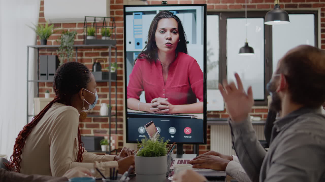 Colleagues meeting with woman on video call conference