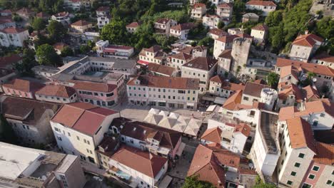 Aerial:-Nikola-Djurkovic-Square's-timeless-charm-in-sunlit-Herceg-Novi,-Montenegro