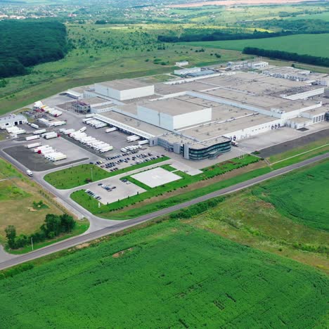 harmful factory in natural environment. huge industrial plant surrounded by beautiful green nature. aerial view. motion back