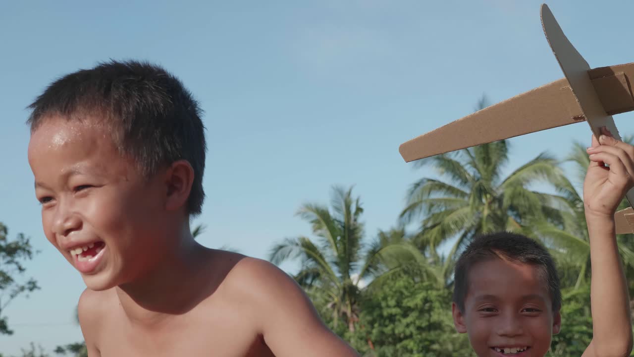Happy Boys Playing with Cardboard Planes