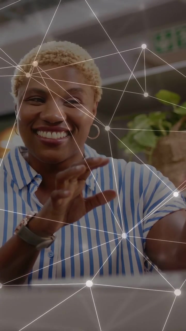 Vertical video: Woman talking and gesturing, animated nodes appearing over device showing tech idea
