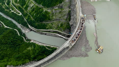 bird's eye view of enguri dam on the enguri river in tsalenjikha, georgia - aerial drone shot