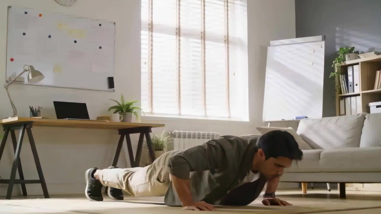 Starting laptop-prompted break, man in blazer performing repeated push-ups on rug in home office