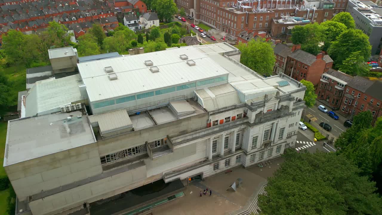 Rising aerial video of Ulster Museum in Botanic Gardens in Belfast, Northern Ireland on a bright sunny day. Produced in 4K, 60 frames per second and with Rec709 color.