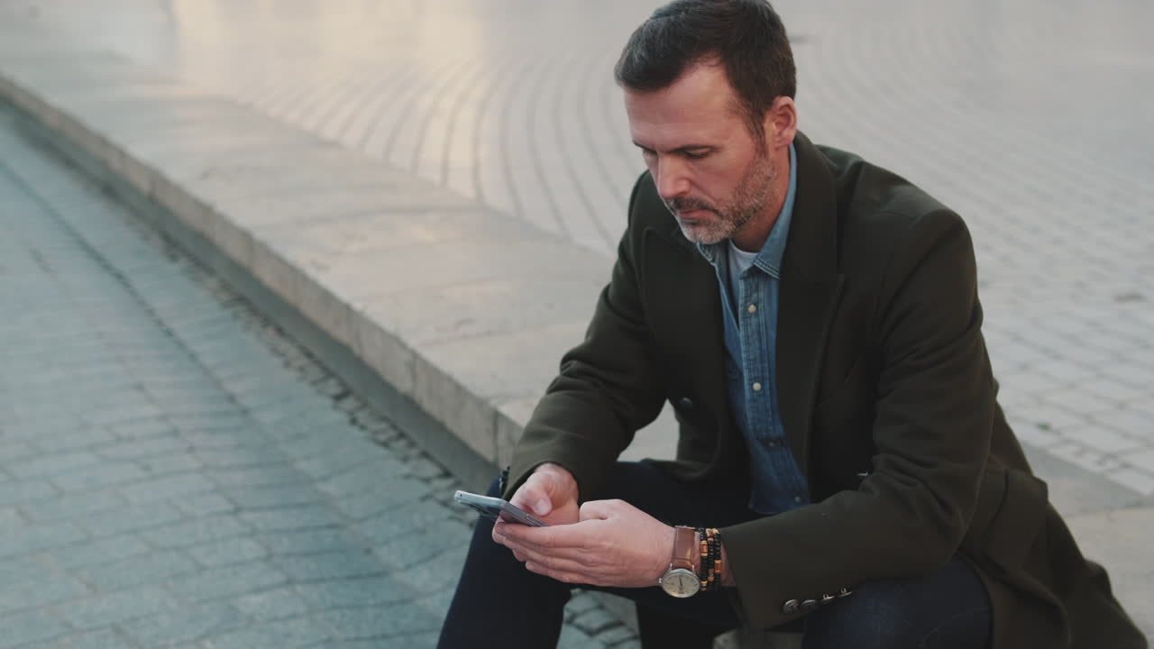 Man using smartphone on street
