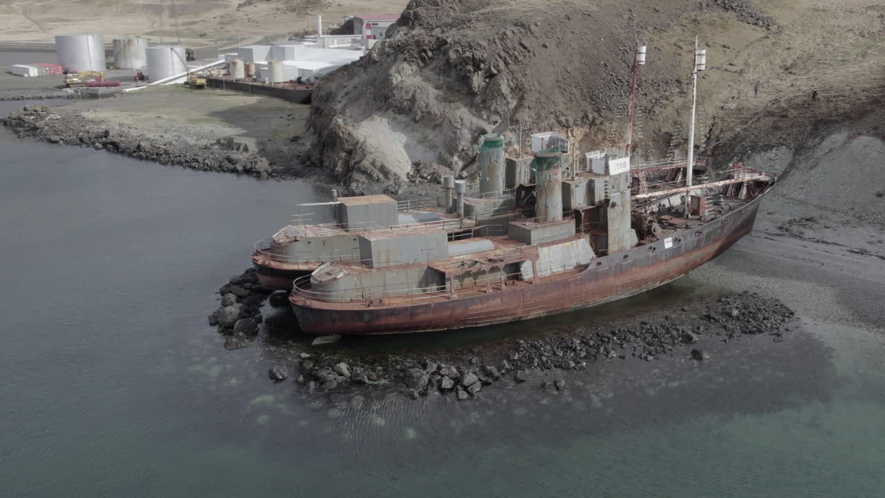 Fantastic aerial shot in a circle over the abandoned whalers located in Hvalfj&ouml;r&eth;ur