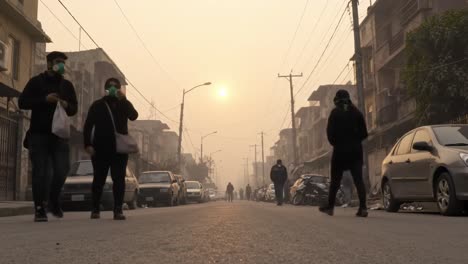 A Busy Urban Street Scene at Dusk Amidst Foggy Weather and People Wearing Masks, Highlighting the Challenges of Air Quality in City Life