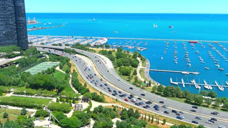 Aerial-rising-shot-of-Lake-Michigan-next-to-Pritzker-Pavilion-in-Chicago-Illinois-|-Afternoon-Lighting