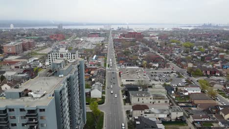 drone flying by apartment buildings in downtown hamilton in the spring