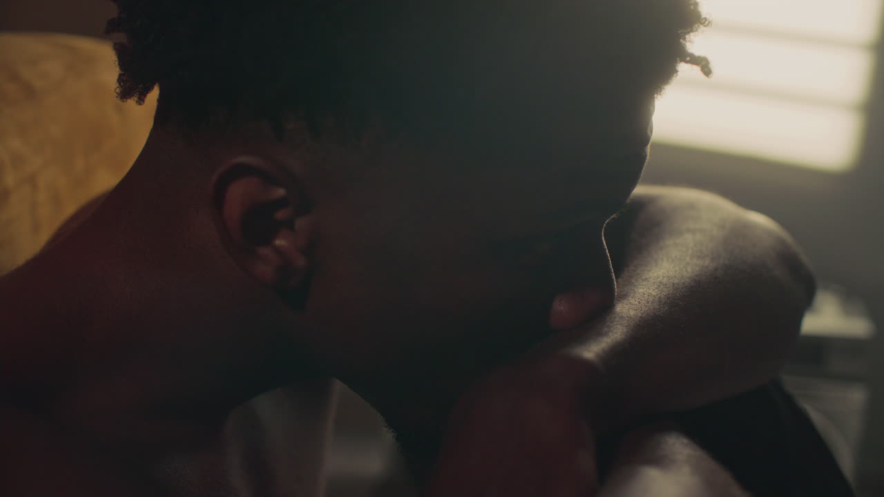 Young Introspective Man Leaning Back and Looking Upward in Thought