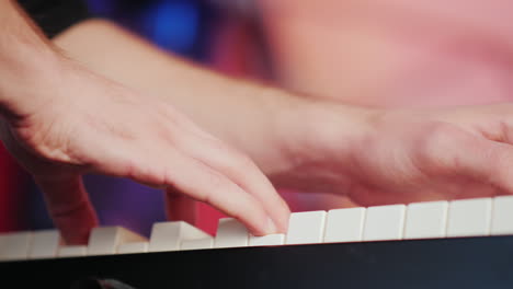 a professional musician plays the synthesizer his fingers press the keys hd video