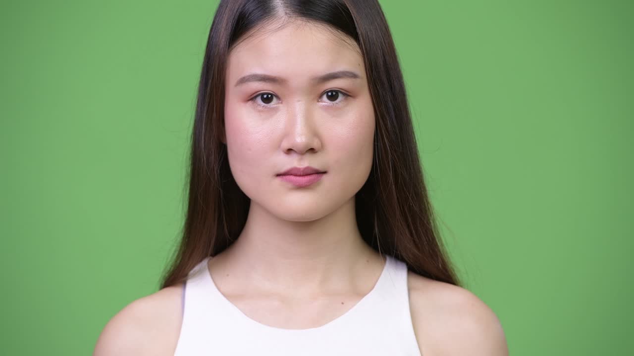 Young beautiful Asian businesswoman smiling