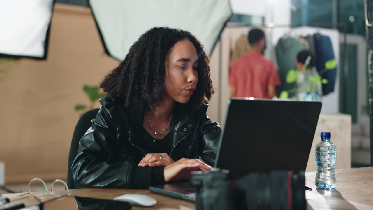 Woman working on laptop in a photography studio