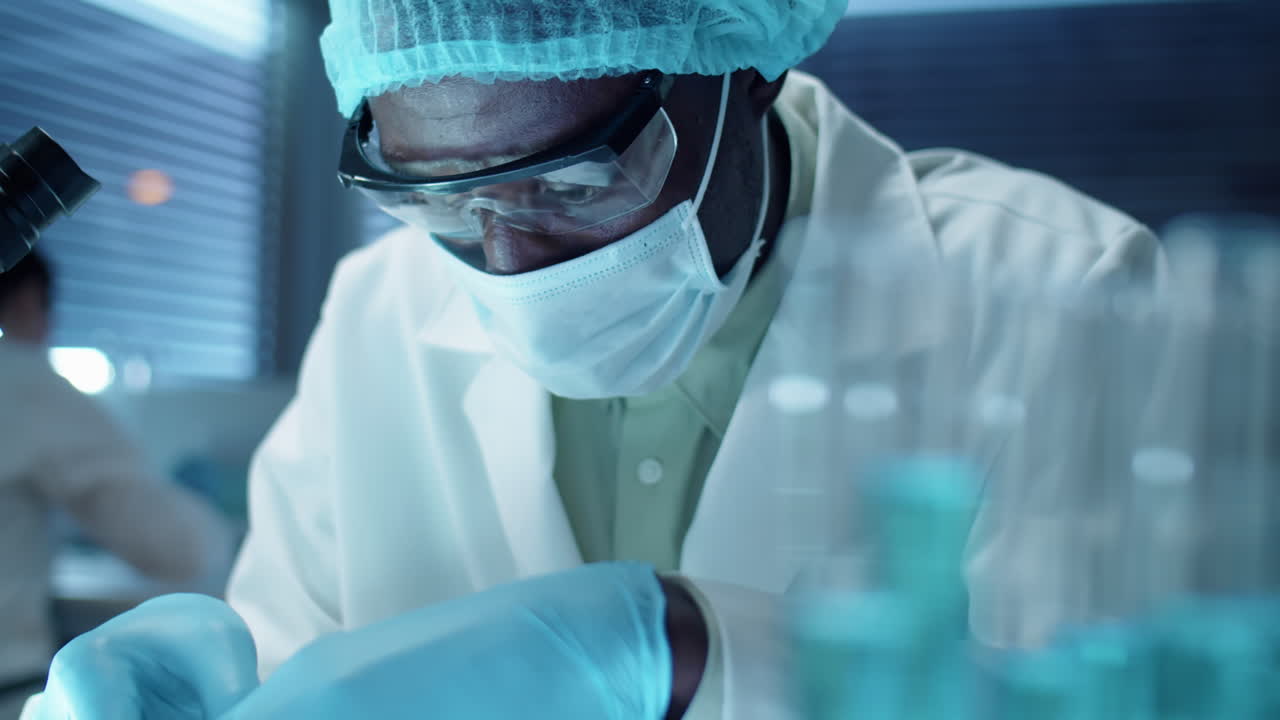 Scientist Examining Plant Leaf in Laboratory