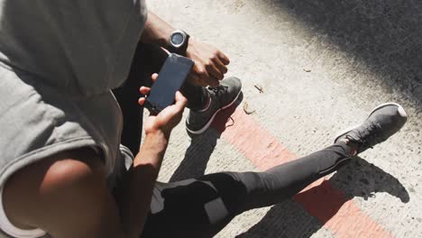 man training in an urban setting taking a break