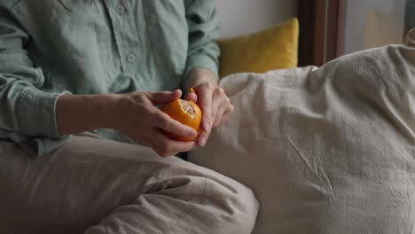 woman peeling an orange