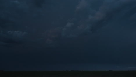 quick flashes of lightning from a powerful thunderstorm light up the night sky