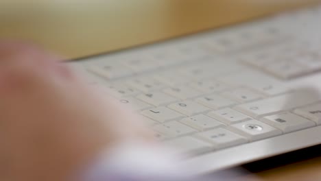 hands typing on a keyboard in a close-up shot