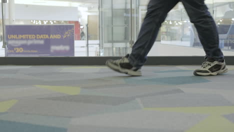 people-walking-by-the-camera-inside-the-shopping-mall