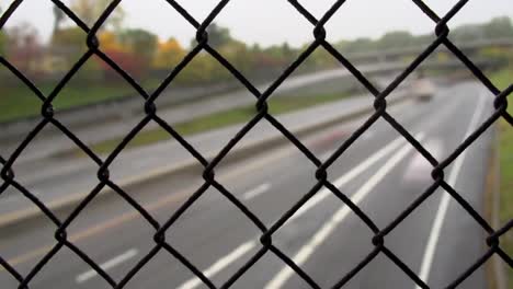 Cars-on-busy-road-with-exit-from-bridge-with-chain-link---USA