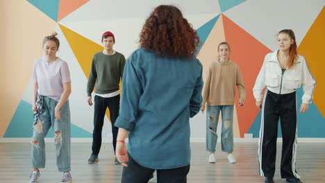 teenagers learning dance in a studio