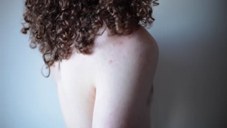 transgender man showing surgery scars on chest