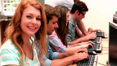 happy student smiling at camera in computer class
