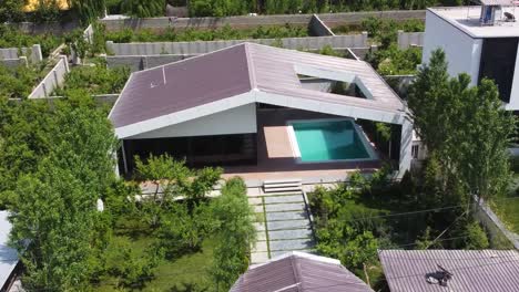 aerial drone shot modern villa luxury architecture design flight over pool garden house green landscape in rural countryside