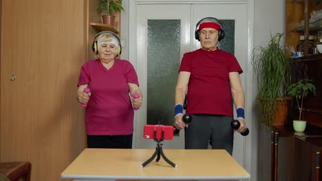 Senior-elderly-couple-grandmother-grandfather-doing-workout-with-dumbbells,-fitness-exercising