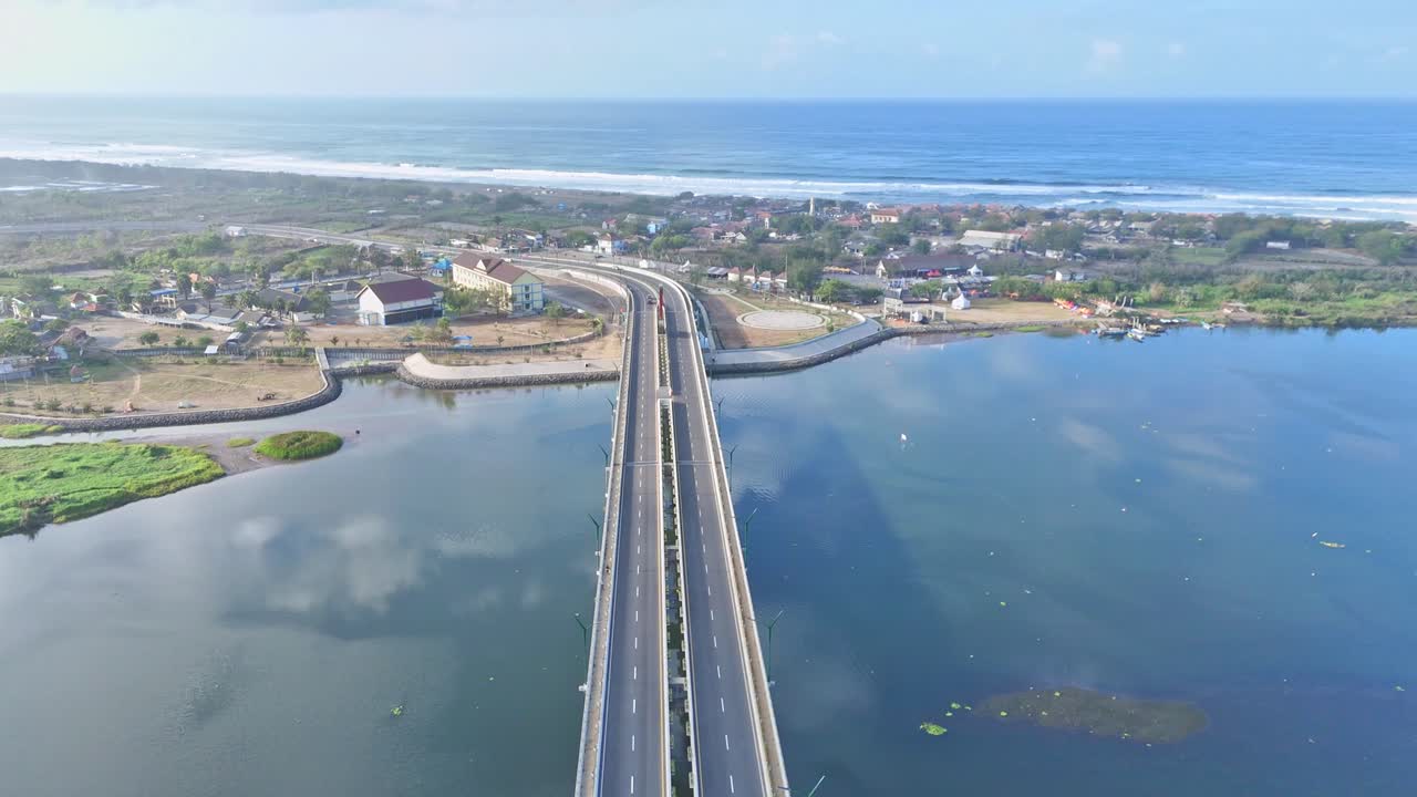 Modern highway bridge and ocean coast in Indonesia, aerial view