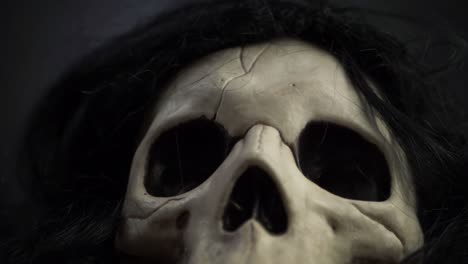 Creepy-skull-with-black-hair-close-up-tilting-shot