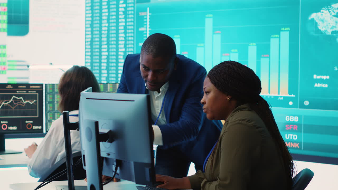 Financial analyst works on resource allocation plans with his staff