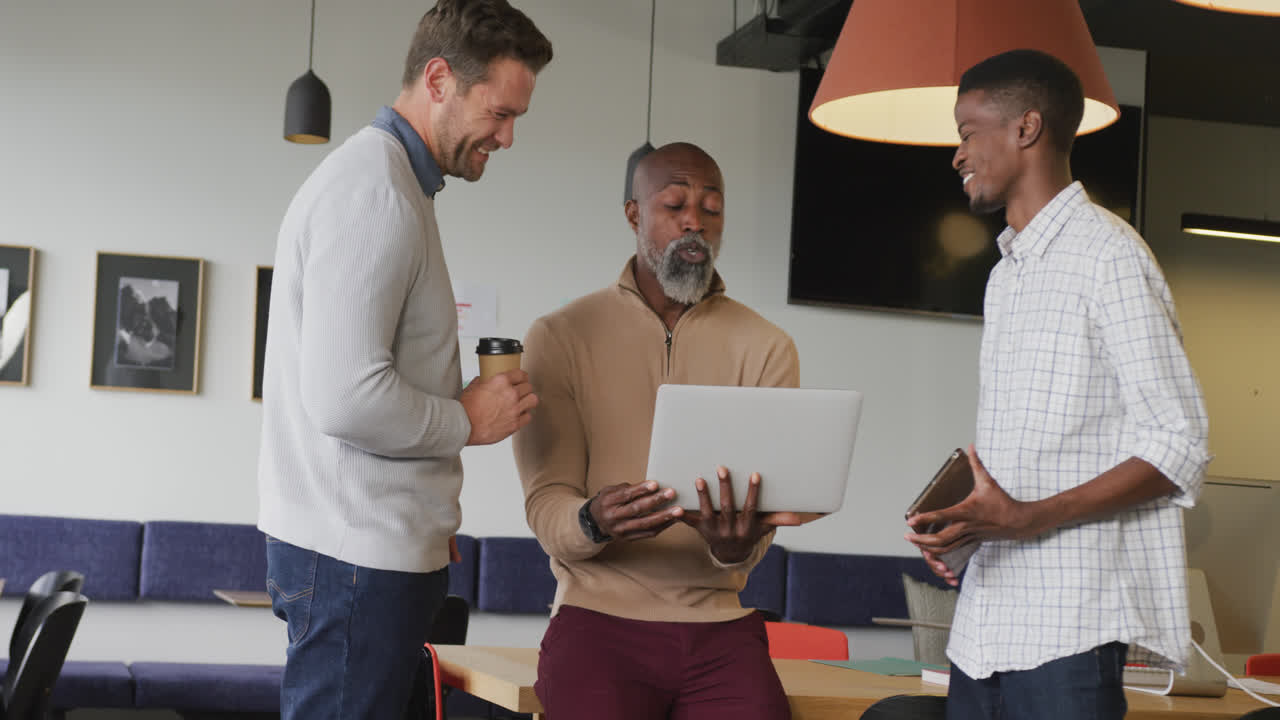 Happy diverse business people discussing work during meeting at office