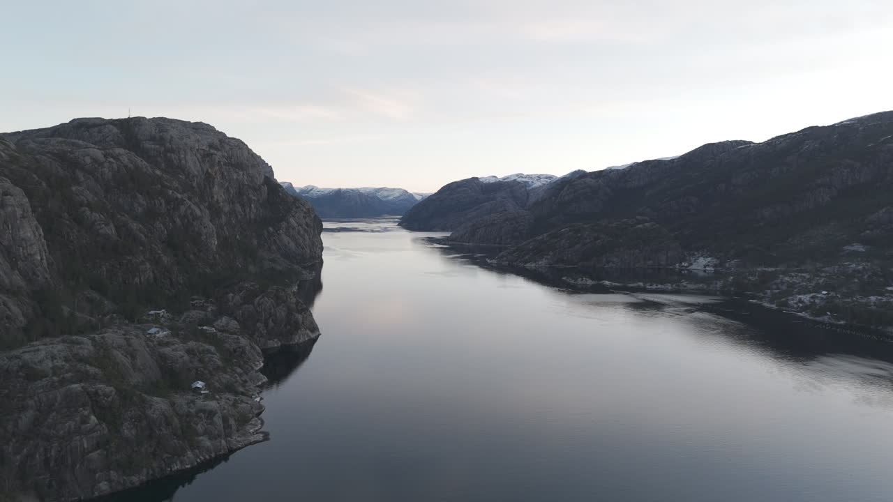 Drone shot flying over the water near Forsand Norway Lysefjord during sunset on a clear day LOG