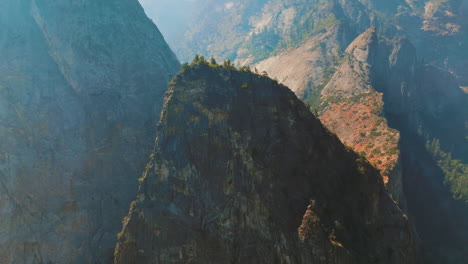 stunning cliff rocks with some scarce pine trees growing on. sunny day footage in yosemite national park, california, usa.