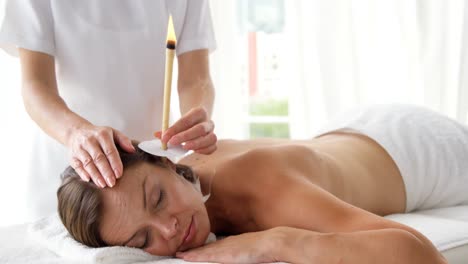 Therapist-ear-candling-her-patient