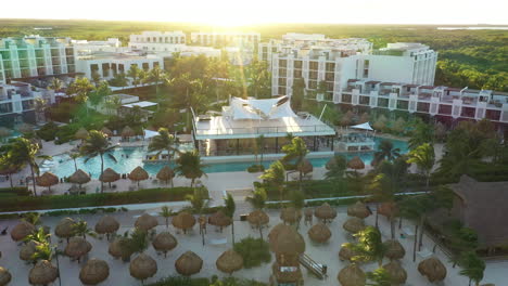 thatched parasols at the hotel resort of finest playa mujeres in cancun, mexico. aerial drone shot