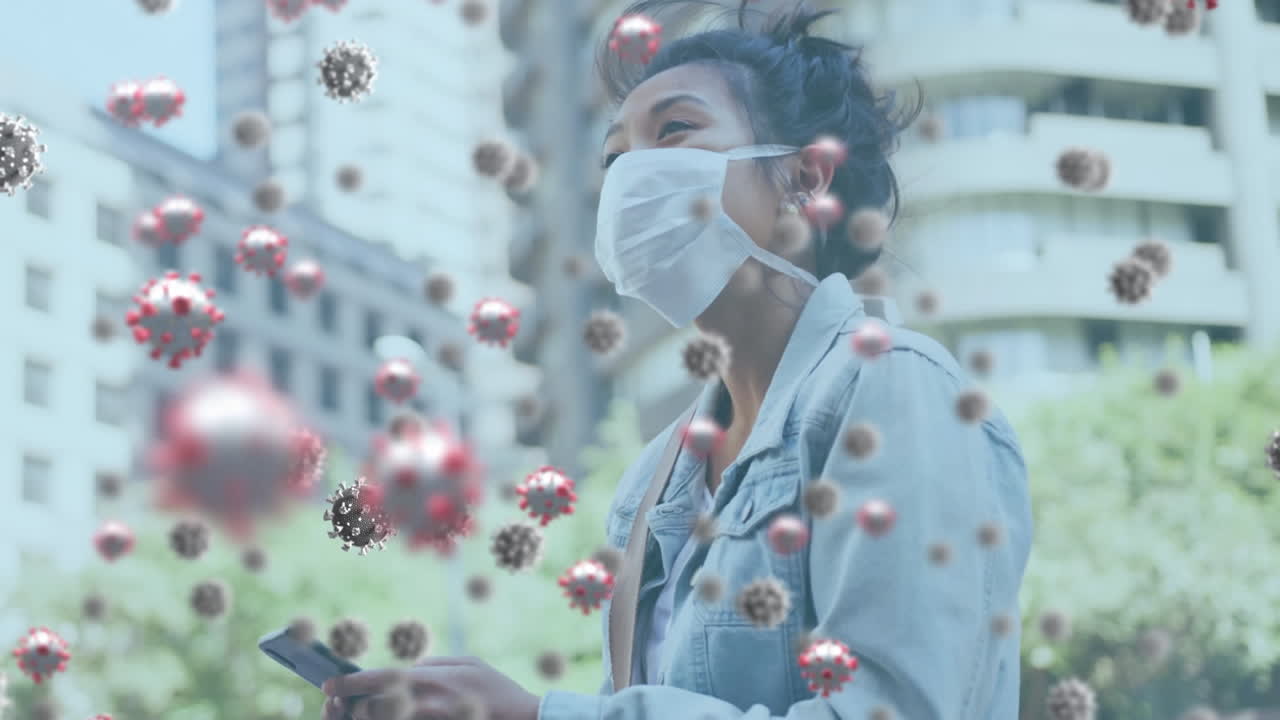 Animation of covid 19 virus cells over woman wearing face mask using smartphone