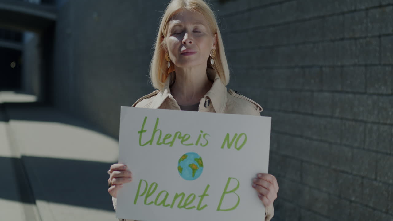 Woman Holding a Sign: "There is No Planet B"