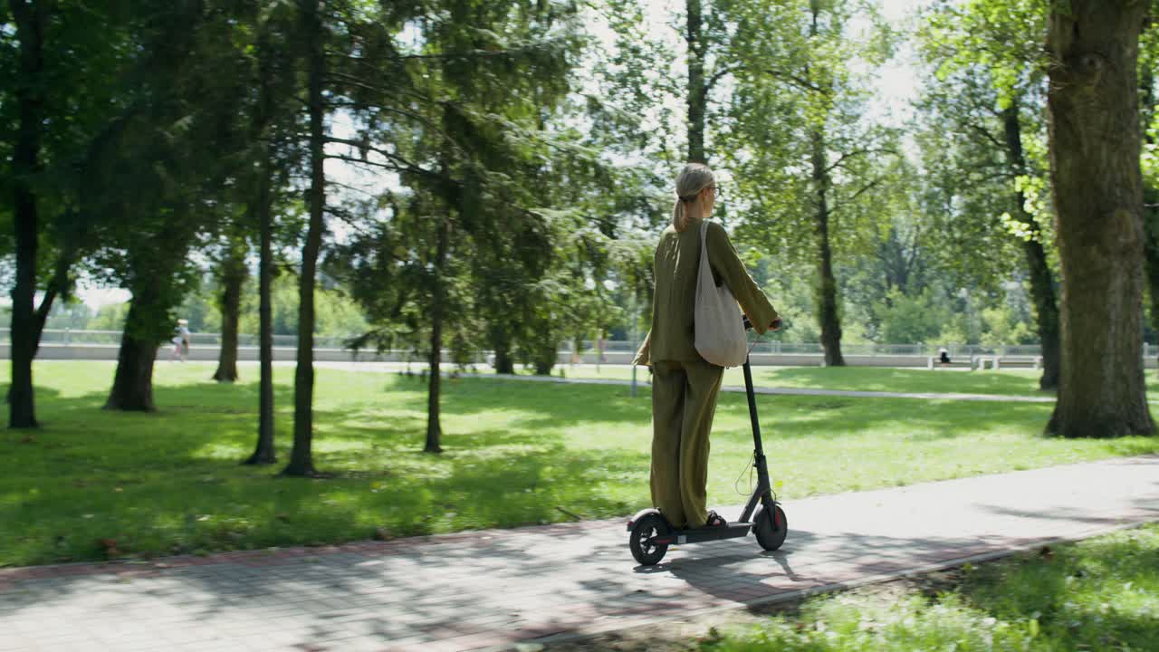 Woman riding an electric scooter in a park