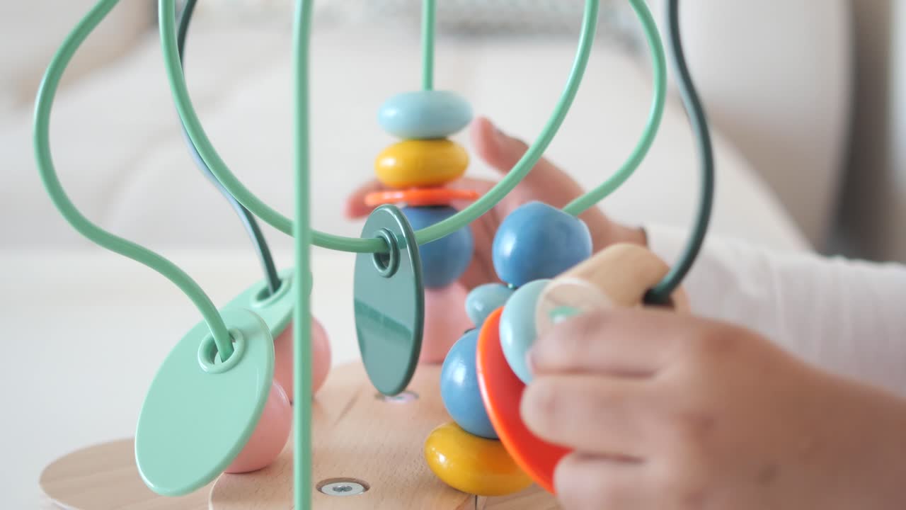 Child playing with a wooden activity toy