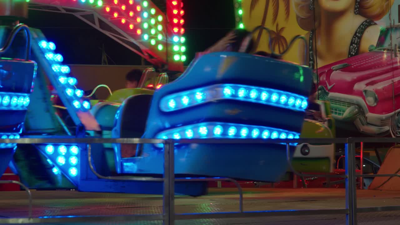 People spinning in a amusement park spinner at night