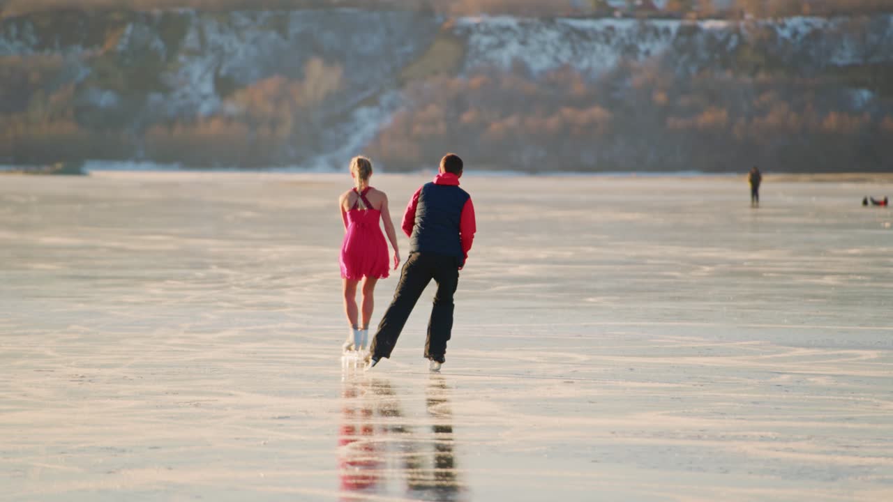 Couple Ice Skating on Frozen Lake