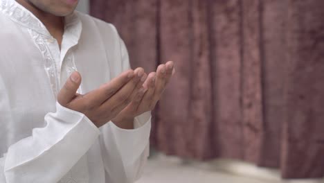 closeup of indian man hand reading namaz