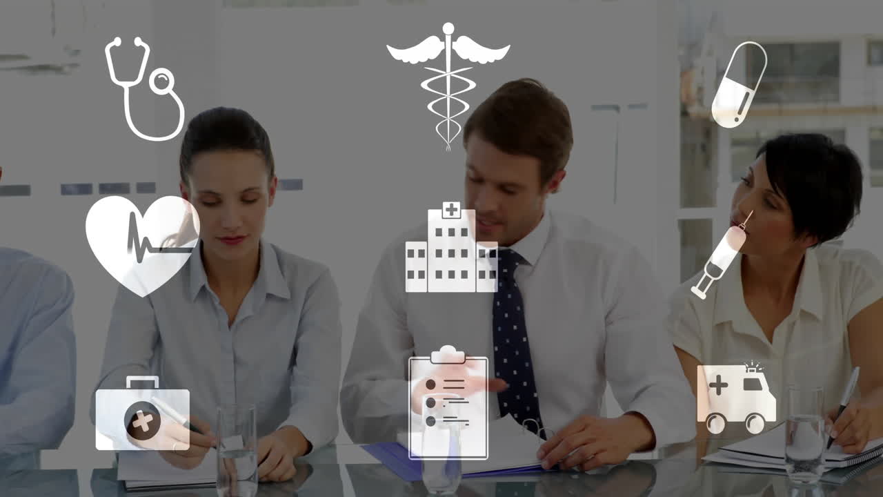 Animated medical icons over diverse healthcare professionals in meeting