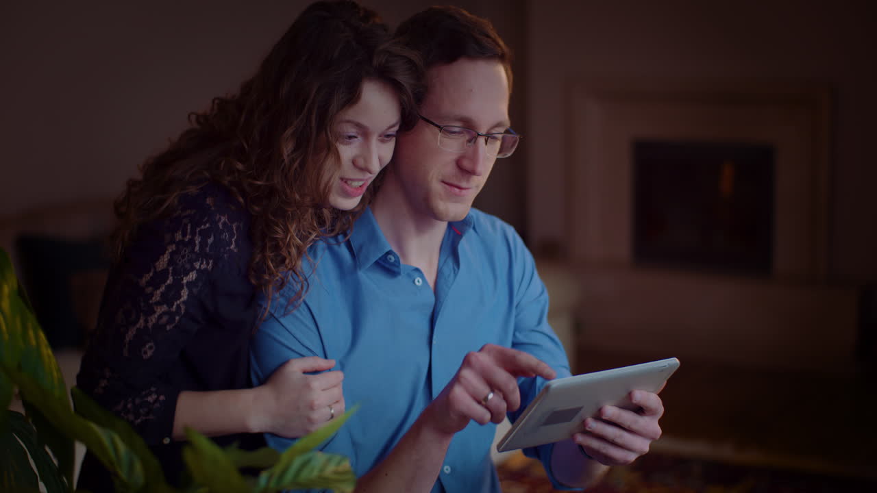 Couple enjoying tablet together at home