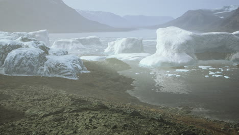 gigantic ice block structures on the black sand by the sea shore