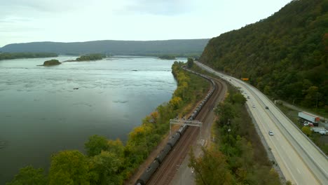 aerial drone view of appalachian mountains and susquehanna river with traffic and train