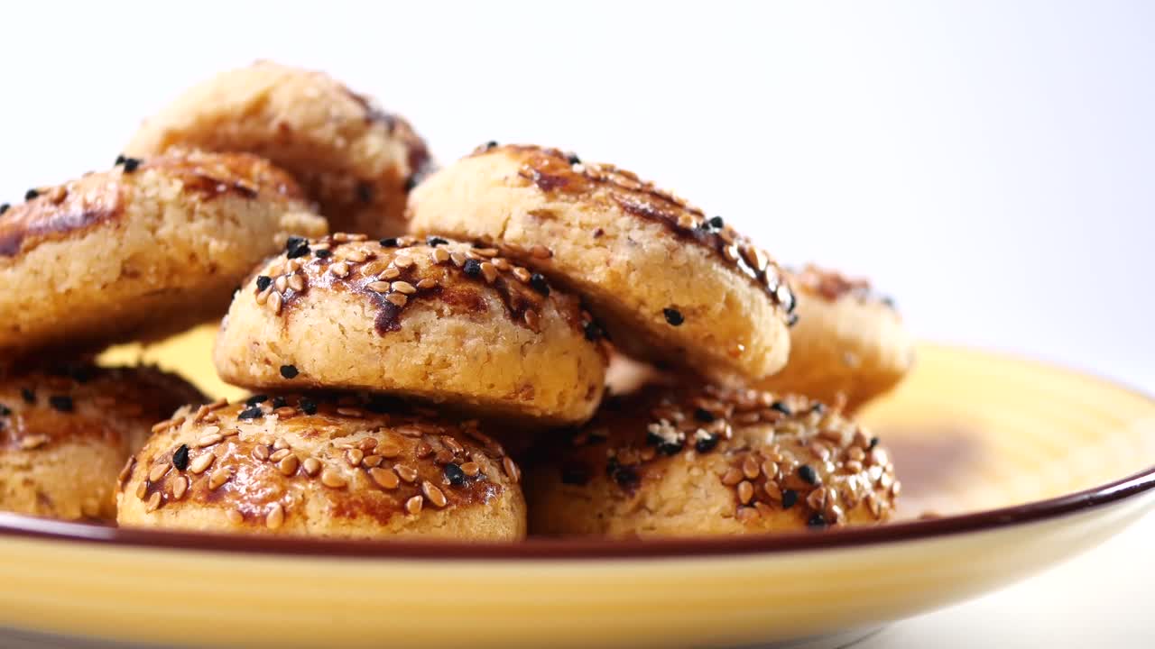 Close-up of Sesame Seed Cookies on a Yellow Plate