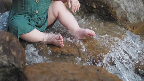 baby playing in a stream